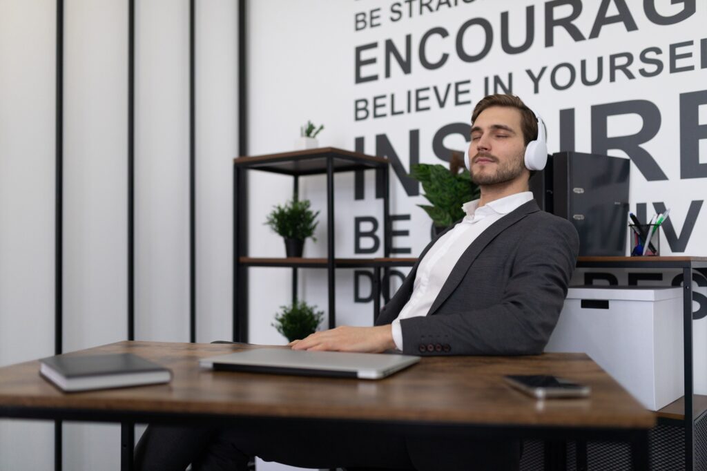 business office worker relaxes during a break listening to music