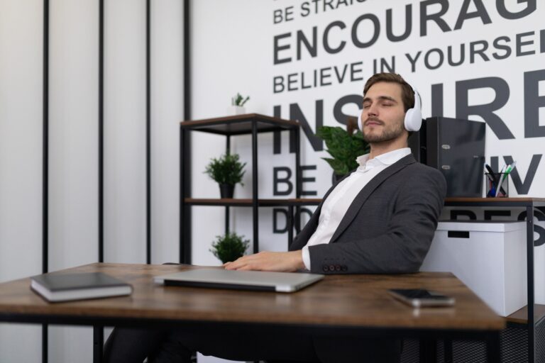 business office worker relaxes during a break listening to music