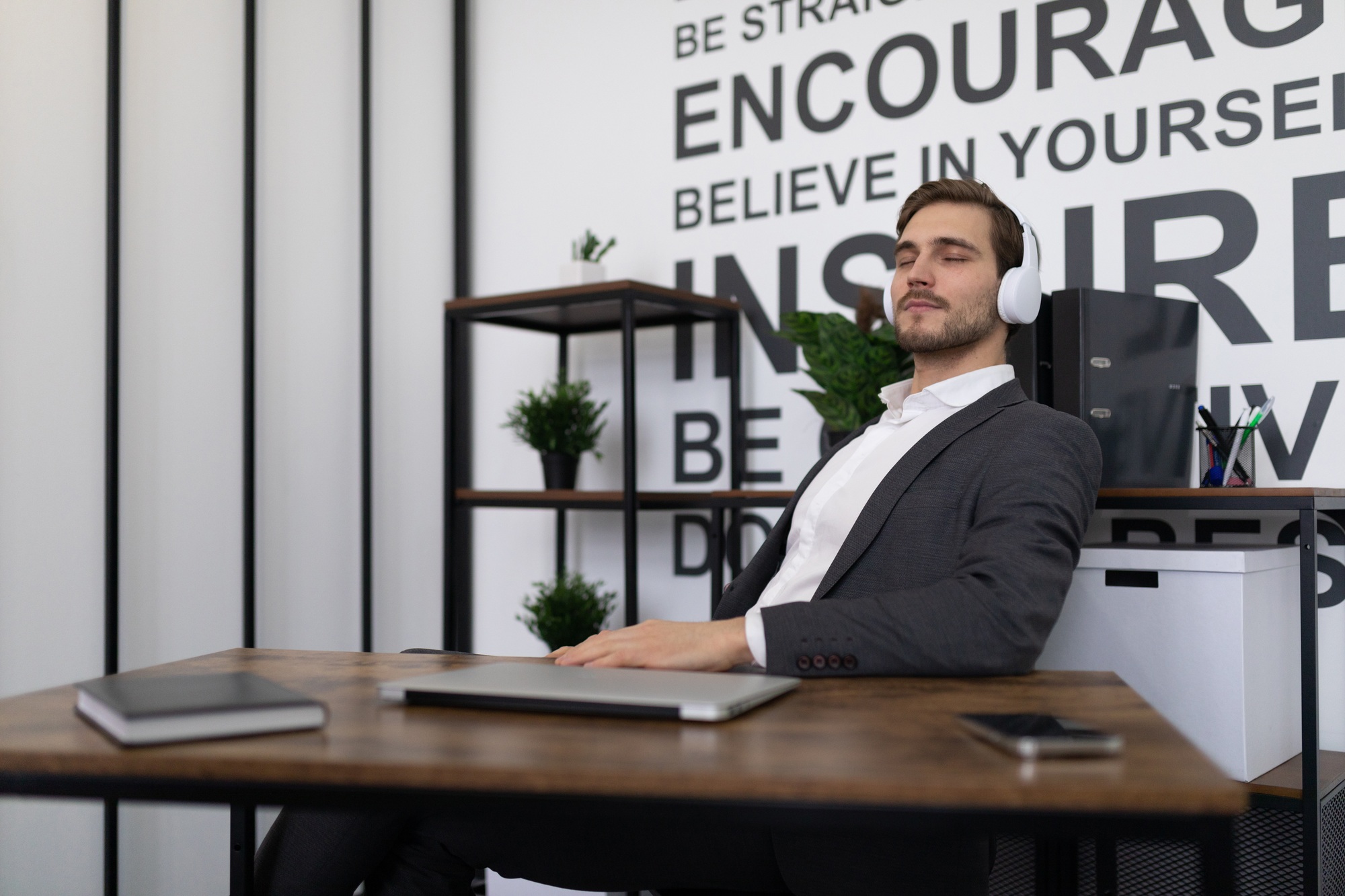 business office worker relaxes during a break listening to music