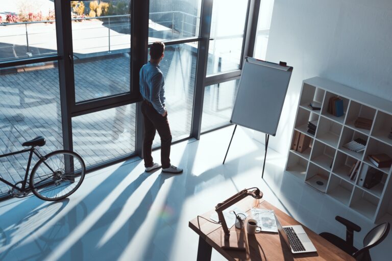 high angle view of young businessman looking at window in office