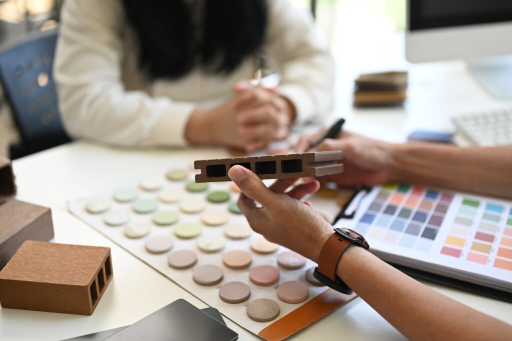 Interior designers working with furniture material samples at co working space in office