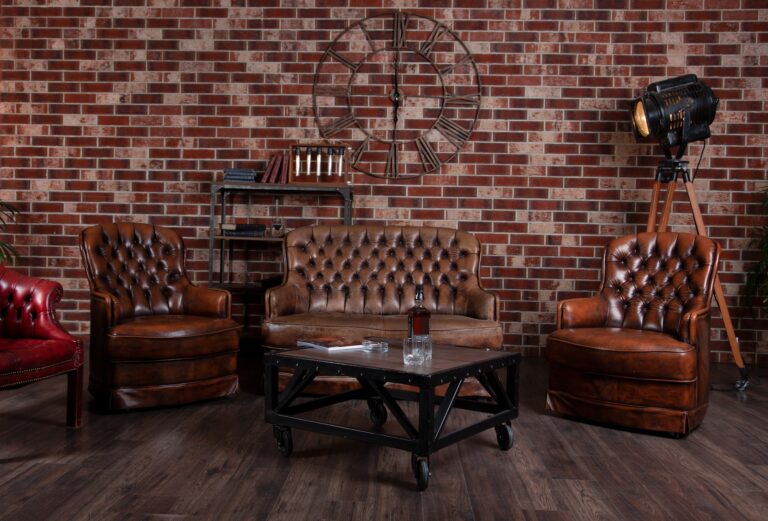 Leather sofa and armchair in the office. Coffee table in the library. Room interior. Old vintage