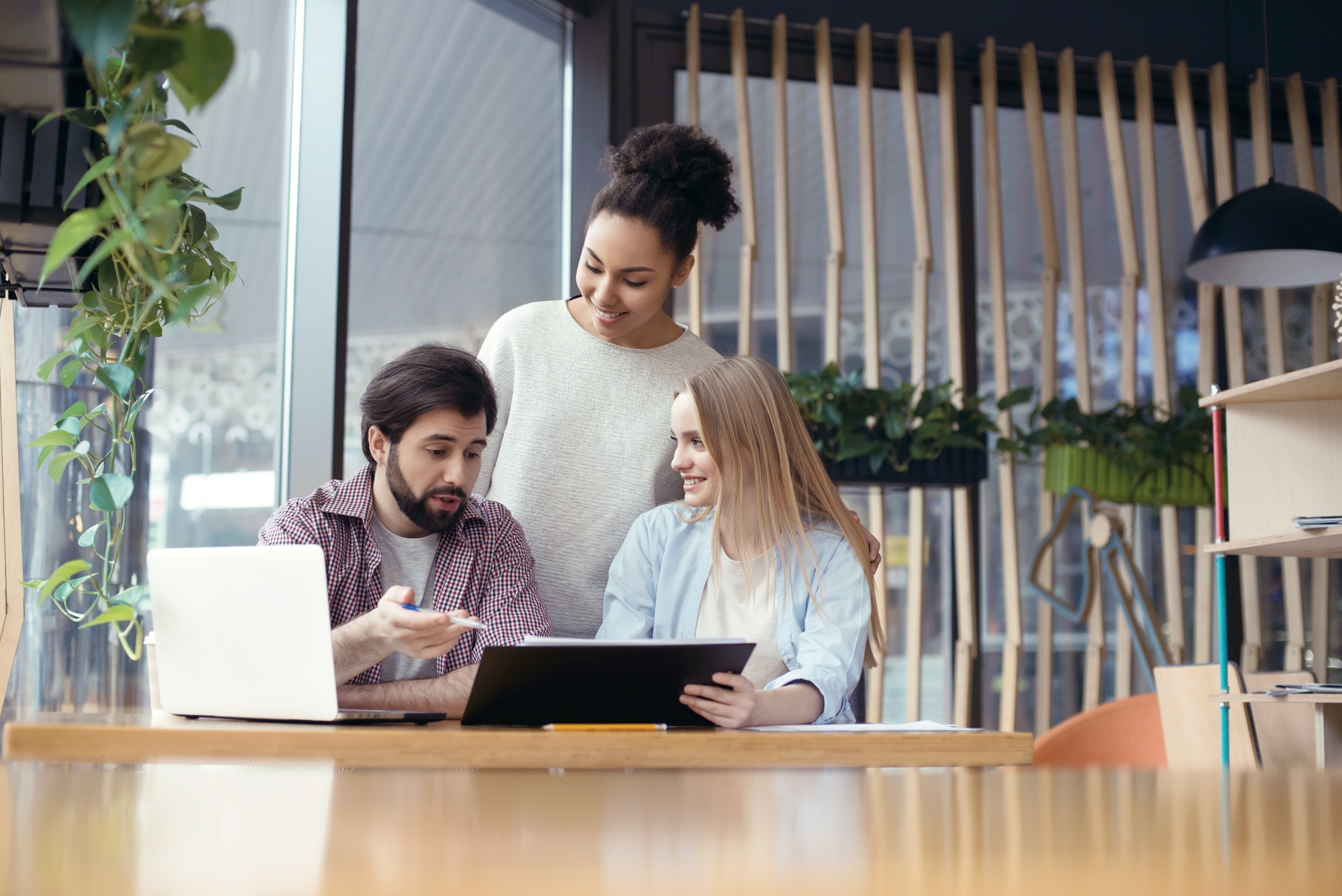 Young people coworking together at creative office sitting boss