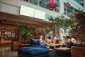 Smiling businesspeople relaxing in the lounge area of an office