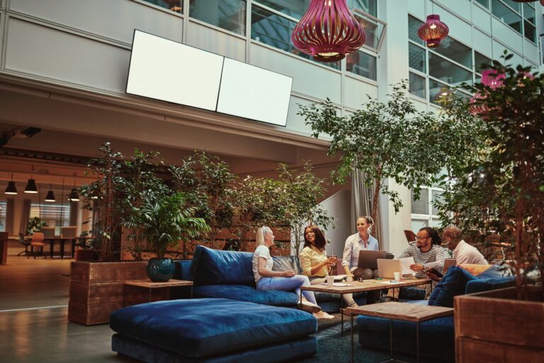 Smiling businesspeople relaxing in the lounge area of an office