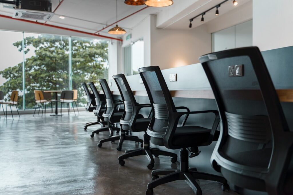 Office ergo chair along a long working table at a co-working space.