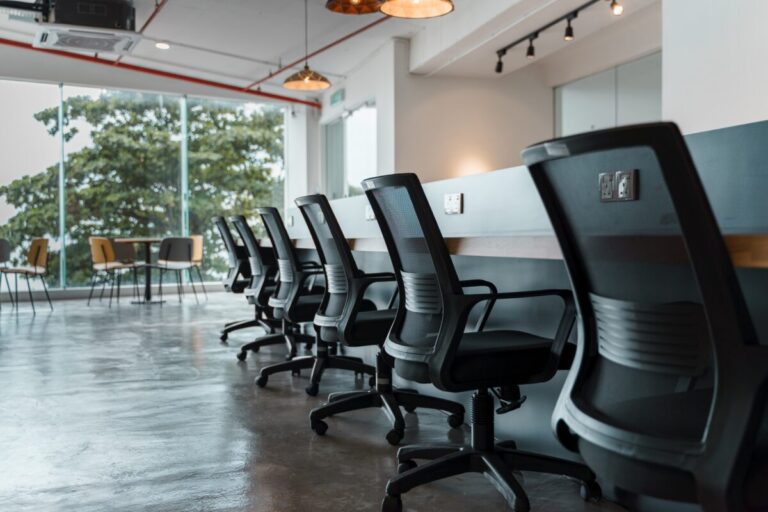 Office ergo chair along a long working table at a co-working space.